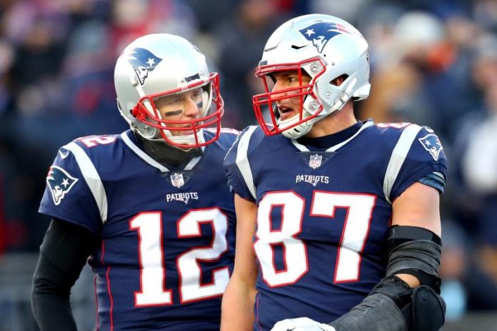 Rob Gronkowski stands next to Tom Brady, both now playing for the Tampa Bay Buccaneers